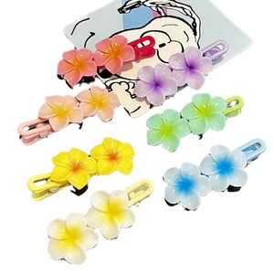 Set of colorful frangipani flower hair clips in seven bright pastel shades for girls