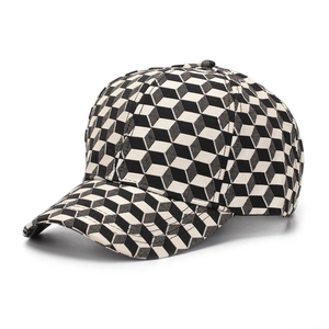 Detail of 3D isometric cube pattern on structured black and white baseball cap
