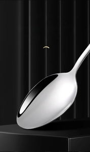 Macro shot of large round stainless steel spoon head with polished mirror finish