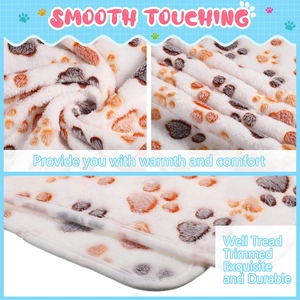 Detail showing smooth flannel pet blanket with paw prints and reinforced edge stitching