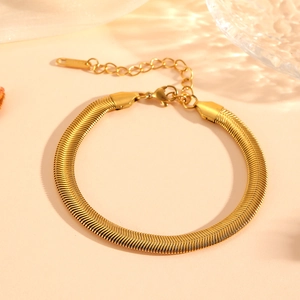 Close-up of golden flat snake chain bracelet with lobster clasp and extension link