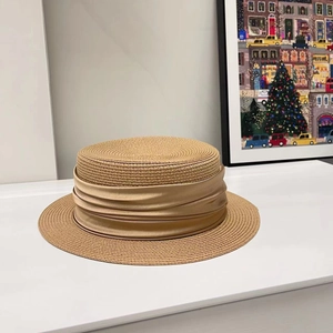 Detail of the champagne pleated ribbon and woven texture on this stylish straw hat