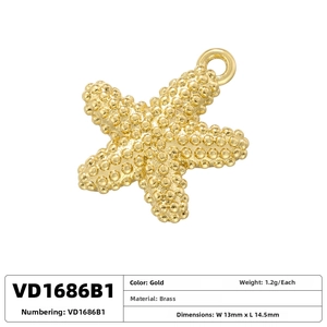 Macro detail of a 13x14.5mm gold brass starfish pendant with textured surface
