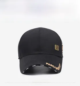 Detail of black baseball cap with golden FARD SPORTCAP embroidery and metal badge