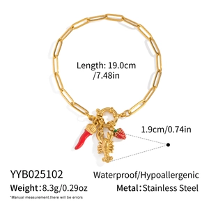 Detail of 18K gold-plated stainless steel bracelet with strawberry and lobster charms