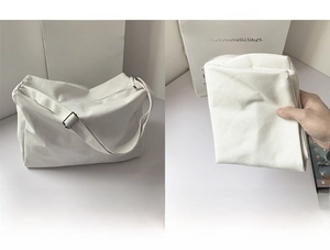 Detail of white canvas bag showing adjustable strap and large capacity storage