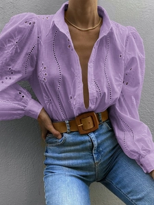 Detail of purple hollow-out embroidery shirt with V-neck and stylish puff lantern sleeves