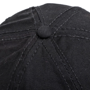 Detail of a black baseball cap top featuring a central button and reinforced stitching