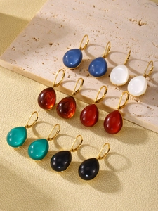 Macro display of colorful resin water drop earrings in six different vibrant shades