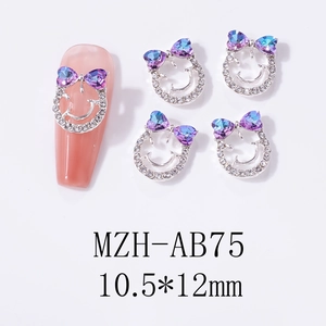 Smiling face nail charm with purple heart bow detail, silver base and clear rhinestones