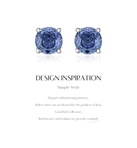 Detailed view of silver stud earrings with tanzanite-colored round-cut stones in 4-prong setting