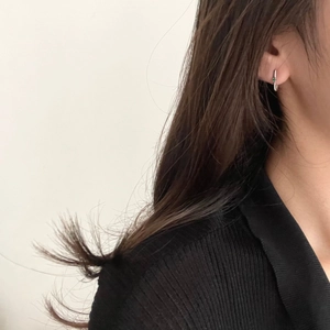 Minimalist 925 sterling silver hoop earrings with green zircon stones on model