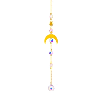 Detailed close-up of brass suncatcher featuring golden moon, sun shapes and crystal prisms
