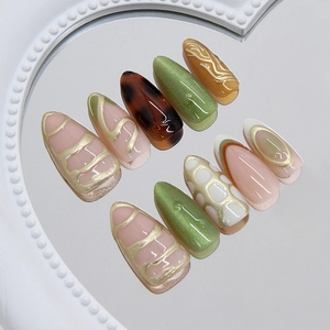 Jade cat-eye press-on nails with 3D gold lines and teardrop shape on mirror base