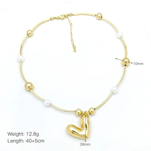 Detail showing dimensions of heart pendant necklace with gold finish and white bead decoration