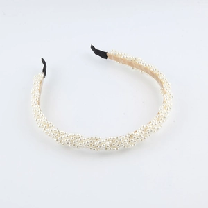 Elegant woven pearl headband with gold metal frame and white round faux pearls
