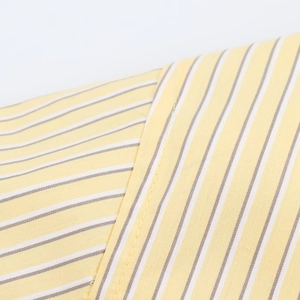 Close-up of yellow and grey striped fabric with precise stitching and high-density texture