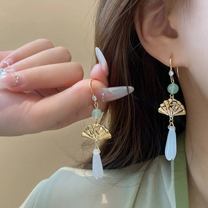 Elegant Chinese style fan-shaped gold earrings with pearl lotus petals on model
