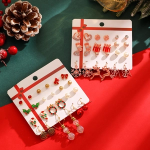 Detailed set of Christmas stud earrings featuring Santa, snowflakes, and elk on a card