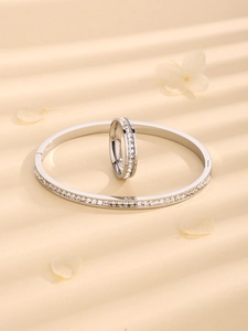 Detailed close-up of silver steel jewelry set featuring sparkling rhinestone pavé inlay