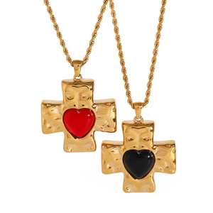 Gold hammer texture cross necklaces with red and black heart center on white background