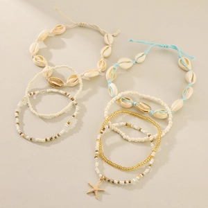 Detail of bohemian multilayer anklet set featuring shell charms and colorful seed beads