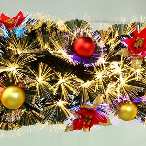 Christmas fiber optic garland with poinsettias and ornaments in warm white light