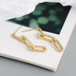 Retro gold geometric chain earrings with sparkling zircon accents on white background