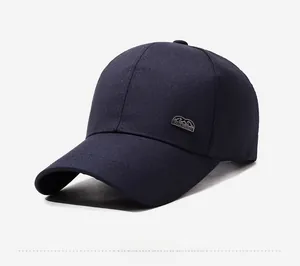 Detail of navy blue baseball cap showing the classic metal side logo and cotton twill fabric