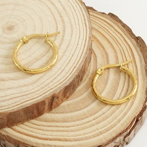 Classic 18k gold plated stainless steel textured hoop earrings on a natural wood surface
