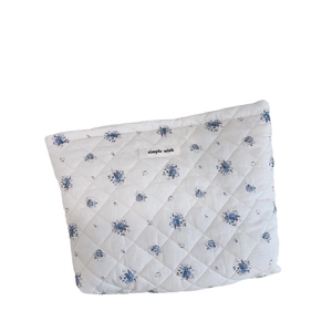 Quilted floral cotton makeup bag in light beige with blue flowers and Simple Wish tag