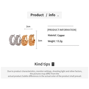 Detailed view of geometric textured copper hoop earrings with 24k gold and silver finish