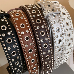Detailed view of punk leather belts featuring silver eyelets, rivets, and rhinestones