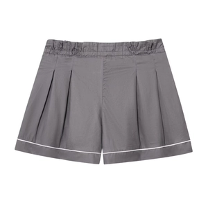 Detail of dark grey pleated shorts with elastic high waist and white contrast trim accents