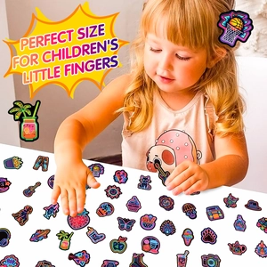 Close-up of a child picking neon stickers featuring cute cat and guitar patterns