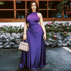 Detail view of the side pleats and waist gathering on this elegant purple maxi dress