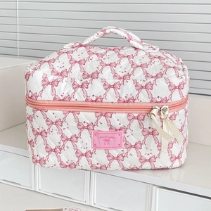 Quilted bow makeup bag with top handle and pink double zippers featuring good night tag