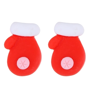 Detail of resin Christmas glove earrings featuring classic red and white festive patterns