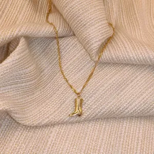 Vintage gold cowboy boot pendant necklace with textured engraving on twisted rope chain