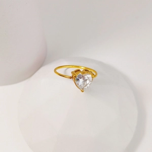 Macro shot of heart-shaped white zircon gemstone set in a minimalist gold-tone ring band