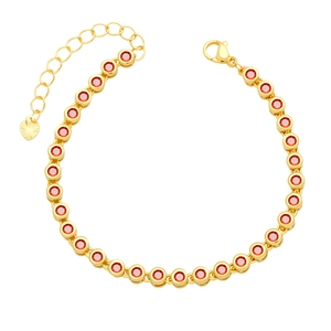 Detailed view of gold bracelet featuring red cubic zirconia and heart charm extender