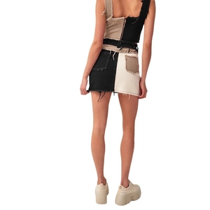 Two-tone black and cream denim set featuring a cropped vest and mini skirt back view