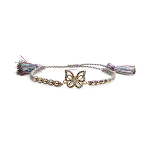 Rainbow woven rope bracelet with gold butterfly charm and colorful zircons on white backdrop