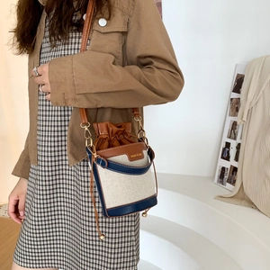 Mini canvas bucket bag in cream with dark blue and caramel leather trim for women