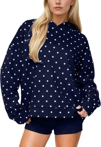 Detailed view of navy blue polka dot hoodie featuring a functional kangaroo pocket