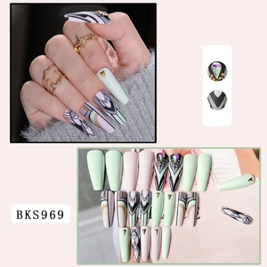 Detailed view of long coffin press-on nails with mint green, geometric patterns and 3D rhinestones