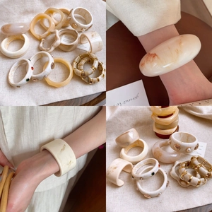 Minimalist resin irregular bangles and rings set in amber marble and cream finishes