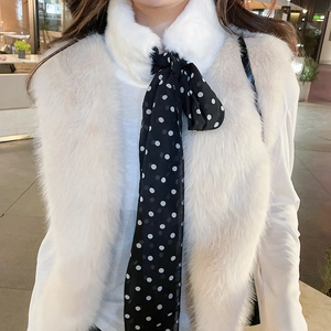 Detailed view of luxury faux fur collar with vintage black and white polka dot ribbon scarf