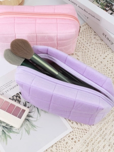 Quilted velvet makeup bags in pink and purple showing interior capacity with brushes