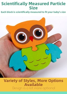 Close-up of owl wooden puzzle pieces held by hand showing compact size and rounded edges